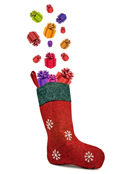 Gifts coming out of red christmas sock — Stock Photo, Image