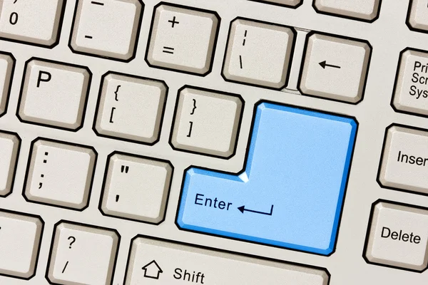 Computer keyboard with blue Enter key — Stock Photo, Image