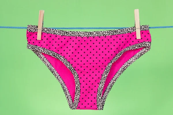 Pink panties on the green background — Stock Photo, Image