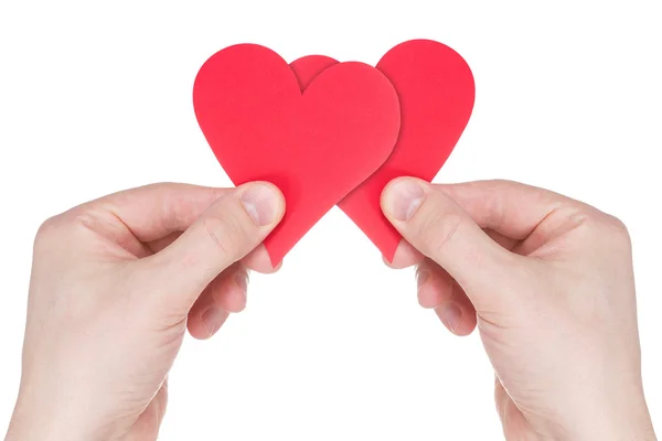 Ruce držící dvě červené papírové srdce — Stock fotografie