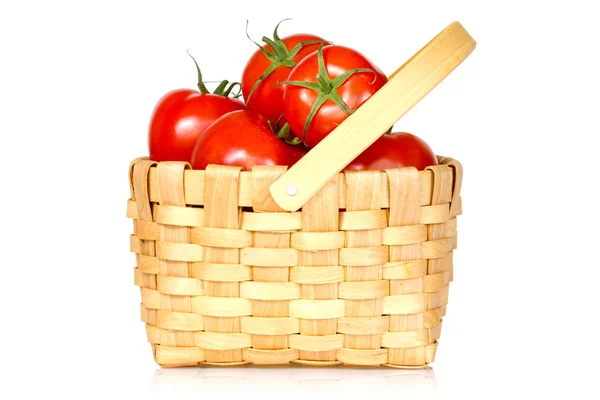 Wicker basket full of tomatoes — Stock Photo, Image