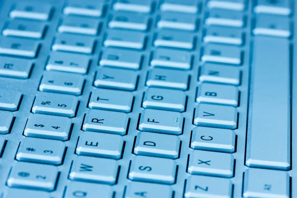 Computer keyboard in blue light — Stock Photo, Image