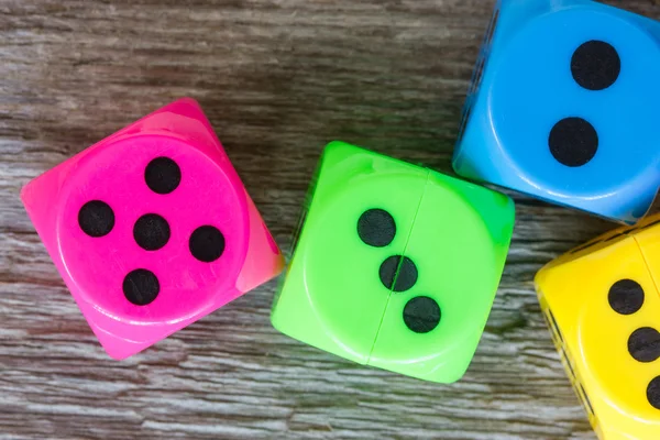 Dice on the old wooden board — Stock Photo, Image