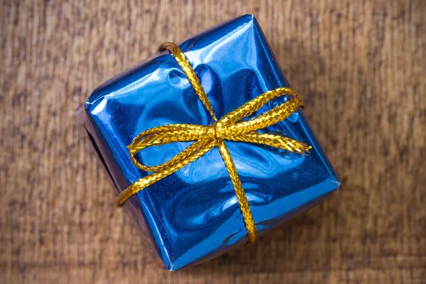 Blue gift box on the board — Stock Photo, Image