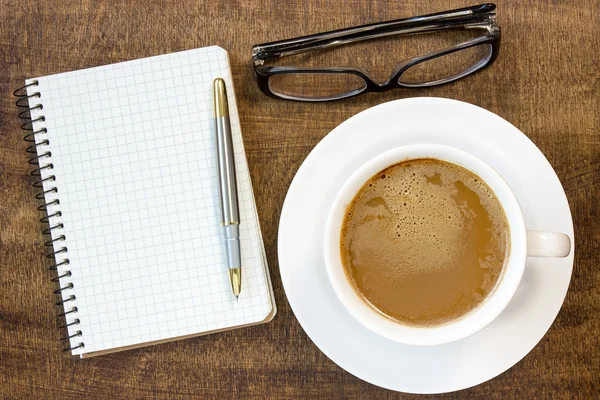 Notebook, glasögon och kaffe kopp — Stockfoto