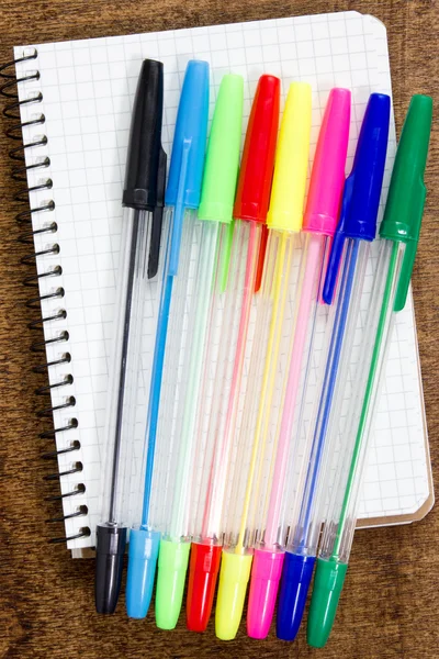 Kolorowe długopisy i notatnik spirala — Zdjęcie stockowe