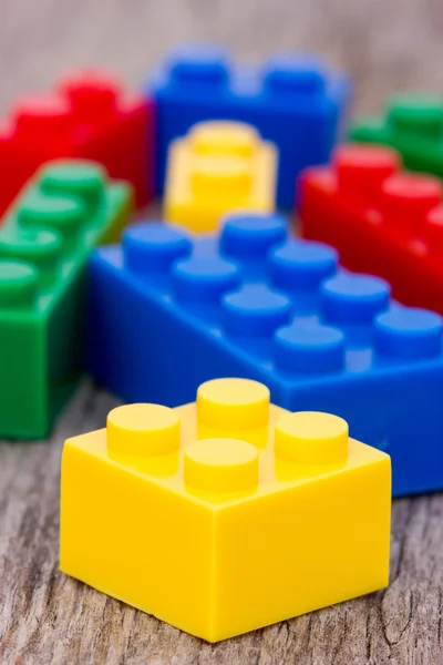 Color plastic blocks on wooden background — Stock Photo, Image