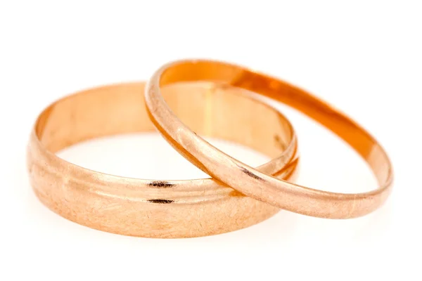 Golden rings on a white background — Stock Photo, Image