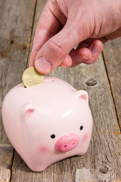 Putting fifty cent  into the piggy bank — Stock Photo, Image