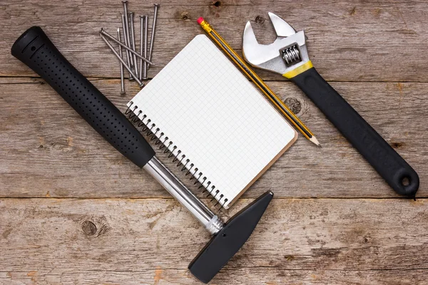 Construction tools and blank notebook — Stock Photo, Image