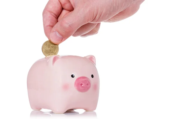 Putting coin into the piggy bank — Stock Photo, Image
