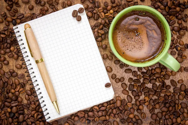 Notebook pen and cup of coffee — Stock Photo, Image