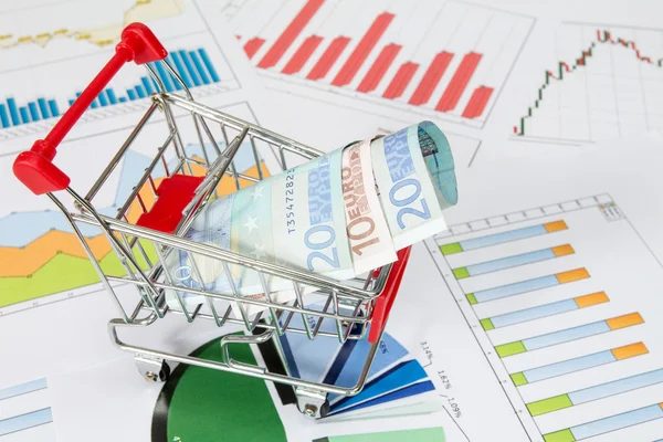 Market cart over business charts — Stock Photo, Image