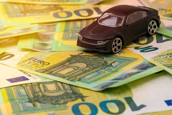 Car pollution tax concept. Car buying concept.Car model and Euro currency.