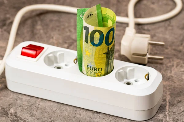ユーロ紙幣の紙幣が延長ソケットに挿入された ビジネスユーザーや住宅顧客のための電気代の増加 電気料金の概念の上昇 — ストック写真