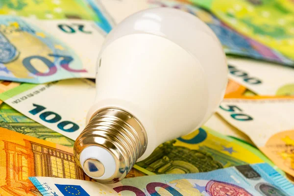 Close Lightbulb Lying Euro Banknotes Increasing Electricity Cost Residential Customers — Stockfoto