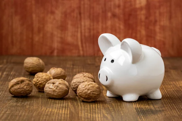Piggy Bank Walnuts Wooden Background Savings Concept — Stock Photo, Image