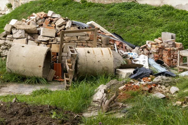 Pile of construction waste.Pile of junk in the yard, recycling and reusing material, hoarding concept, construction material scrapped in backyard after clean up or reconstruction work, DIY house renovation.