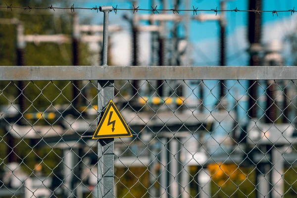 Electrical hazard sign placed on a fence of an high-voltage substation.
