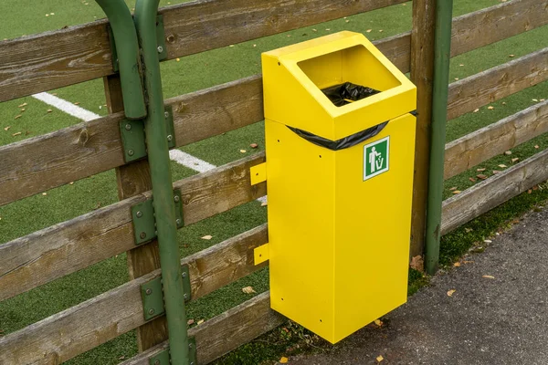 Yellow Garbage Bin Hanging Wooden Fence Sports Ground — Stock Photo, Image