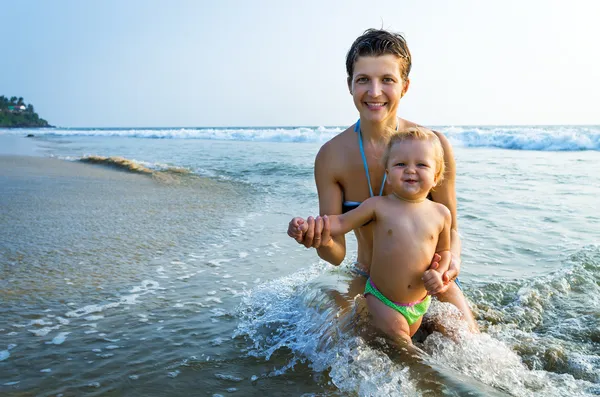 Happy family resting at tropical beach Stock Picture