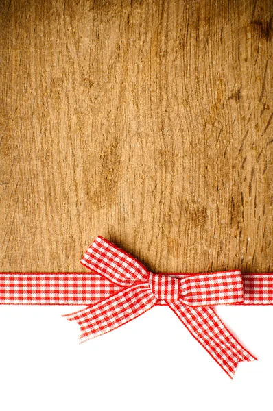 Wooden background with a red checkered ribbon — Stock Photo, Image