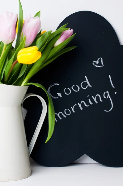 Bouquet of tulips and chalk board — Stock Photo, Image