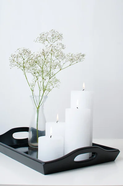 Branch in a vase, and four white candles — Stock Photo, Image