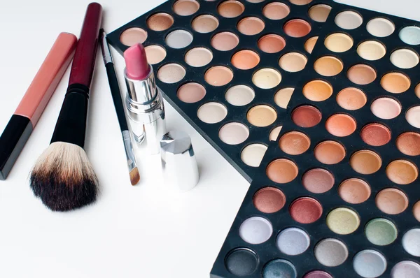 Colorful eyeshadows, lipstick and makeup brushes — Stock Photo, Image