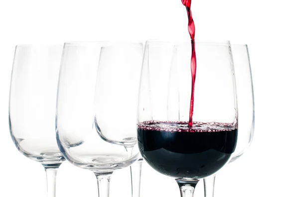 Red wine pouring into empty glass — Stock Photo, Image