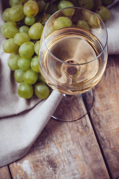 Sklenice bílého vína a hroznů — Stock fotografie