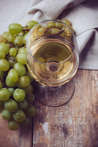 Glas witte wijn en druiven — Stockfoto