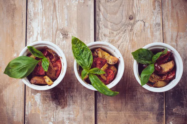 Vegan food: three plates of grilled vegetables