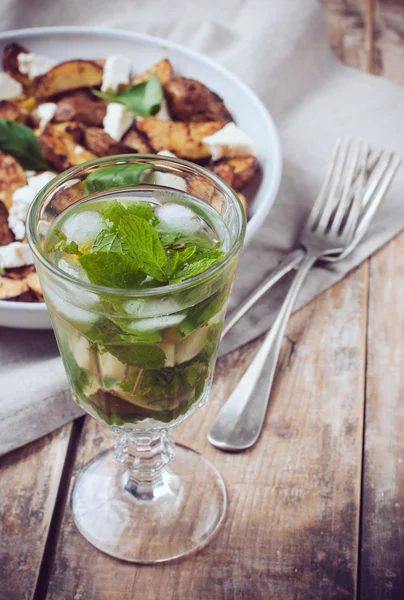 glass of drink and a baked potato