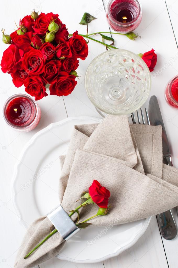 Festive table setting with red roses