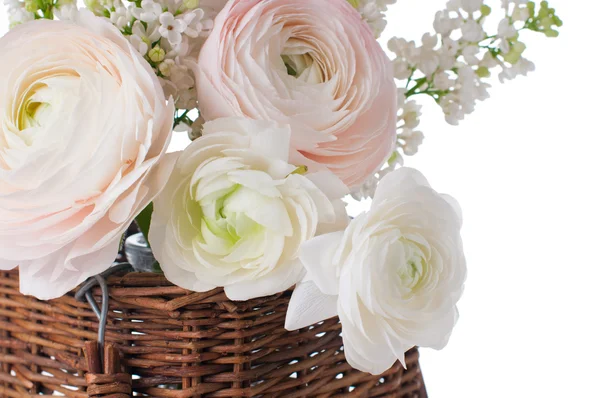 Buttercups and white lilac in a wicker basket — Stock Photo, Image