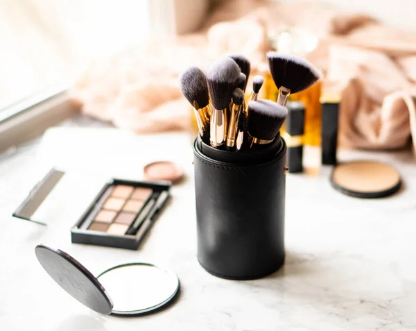 Set of luxurious black makeup brushes in leather case — Stock Photo, Image