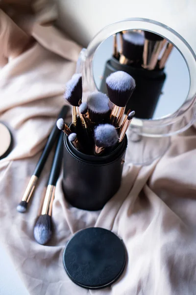 Set of luxurious black makeup brushes in leather case — Stock Photo, Image