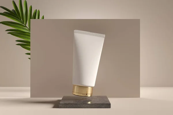 Care product package, cosmetic cream white tube mock-up with palm leaf on beige studio background 3D render