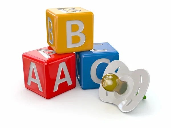 ABC blocks cube and baby's dummy — Stock Photo, Image