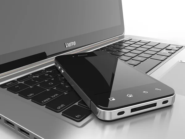 Laptop en mobiele telefoon. — Stockfoto