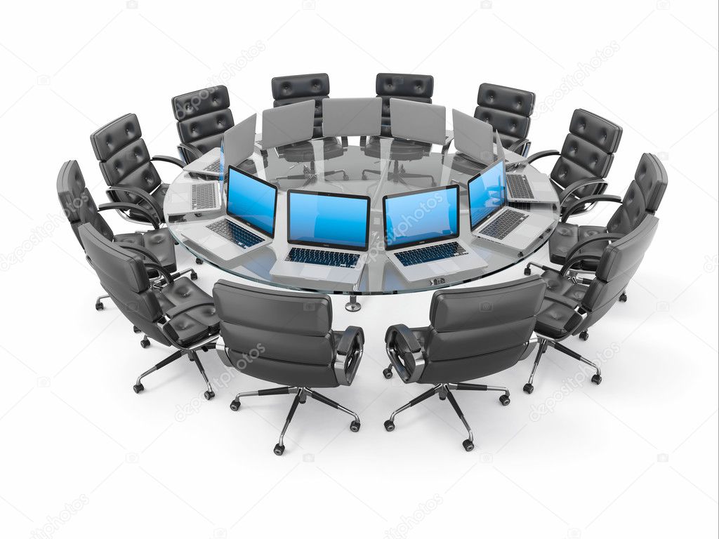 Conference table with laptops and armchairs