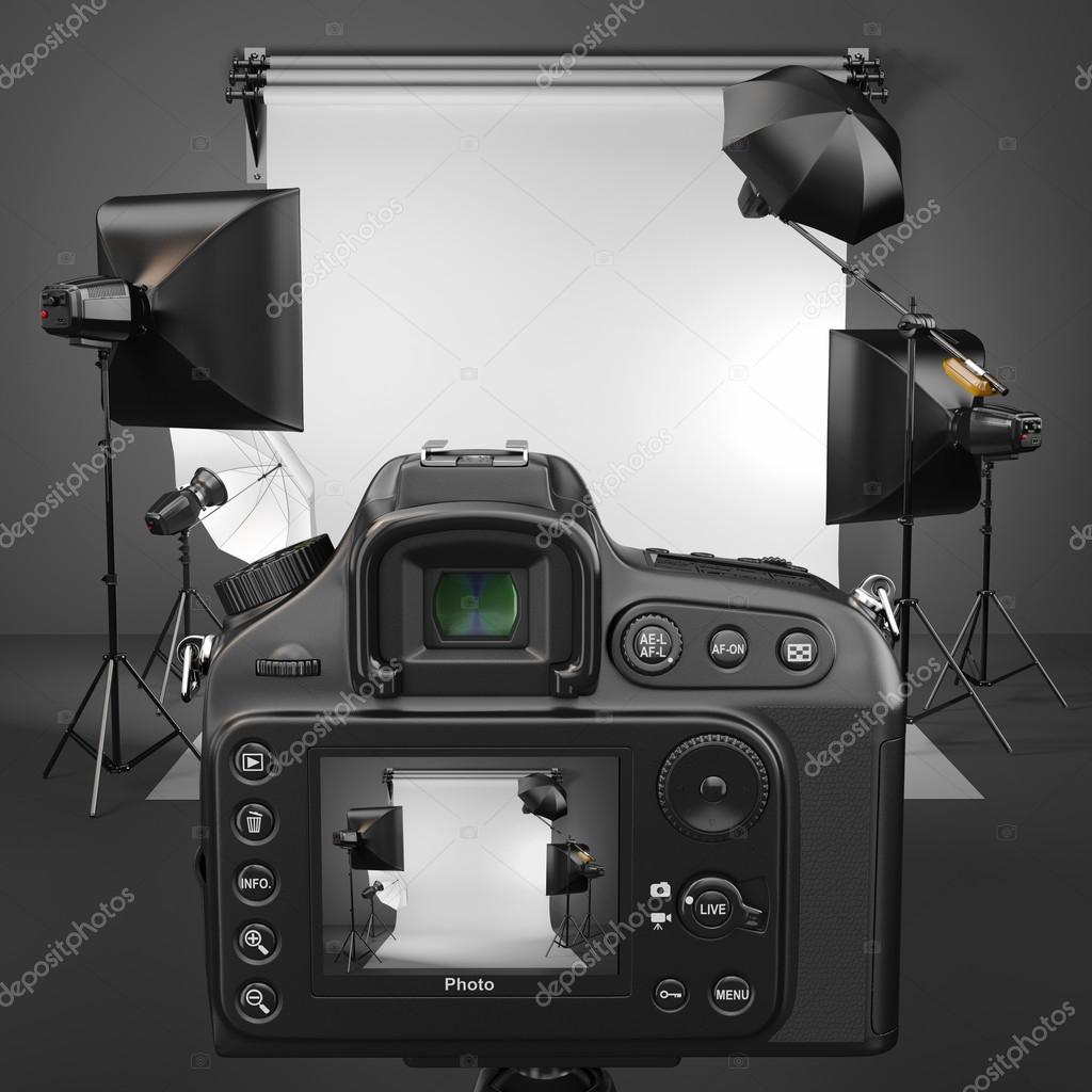 Digital photo camera in studio with softbox and flashes. Stock Photo by