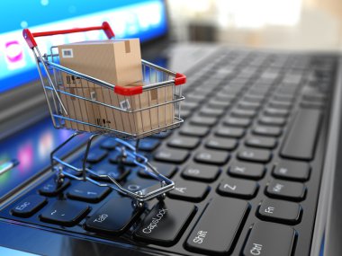 E-commerce. Shopping cart with cardboard boxes on laptop. clipart