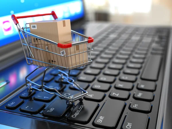 Comercio electrónico. Carrito de compras con cajas de cartón en portátil . —  Fotos de Stock