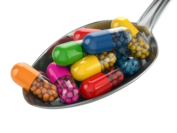 식이 보조 제. 다양 한 알 약입니다. spoo에 비타민 캡슐 — 스톡 사진