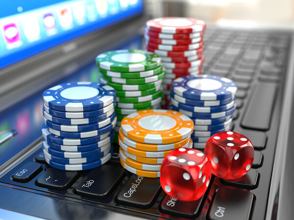 Virtual casino. Online gambling. Laptop with dice and chips.