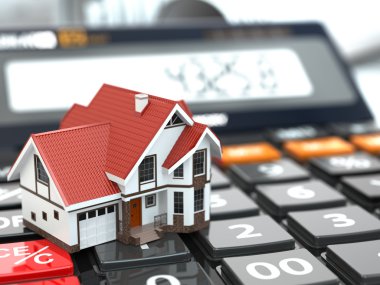 Real estate concept. House on calculator. Mortgage. clipart