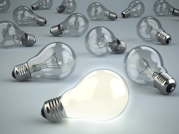 Idé koncept. lampor på grå bakgrund. — Stockfoto