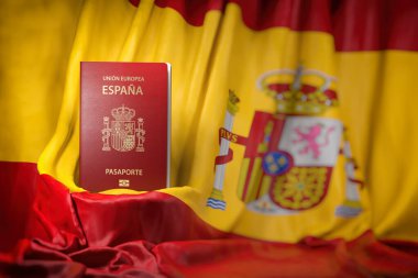 İspanya pasaportu İspanyol bayrağında. Vatandaşlık, göç, seyahat ve turizm konsepti. 3d illüstrasyon